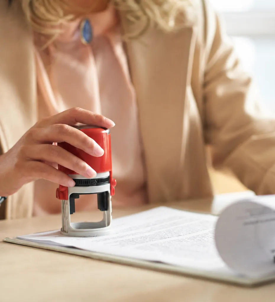 A notary stamping an official document during an appointment